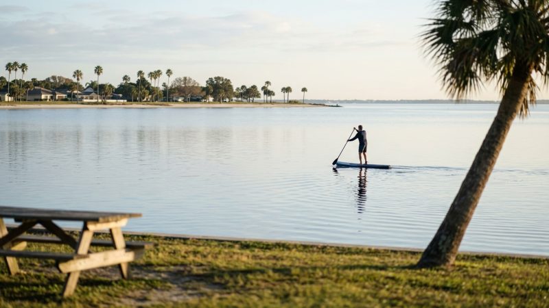 Paddleboarding on calm bay water off Crown Point, San Diego